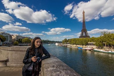 Full length of young woman looking at city