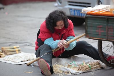 Full length of woman sitting on book