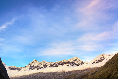 Scenic view of mountains against cloudy sky