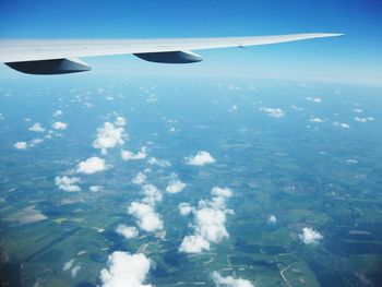 Aerial view of aircraft wing against sky