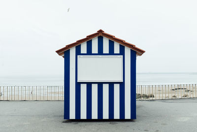 Beach hut against clear sky