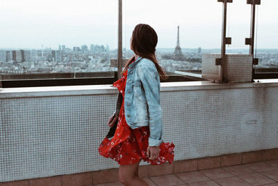 Side view of woman looking at view on terrace