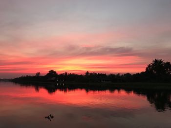 Scenic view of lake against orange sky