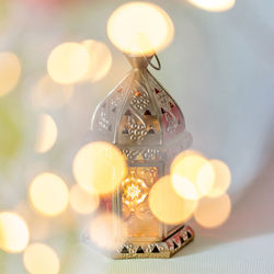 Close-up of illuminated lamp on table