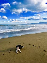 Full length of man on beach against sky