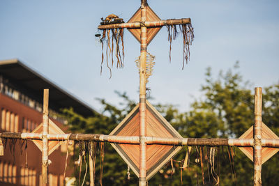 Low angle view of decoration hanging on tree against sky