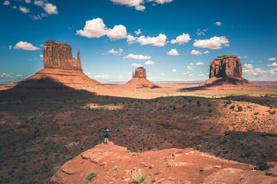 Scenic view of rock formations against cloudy sky