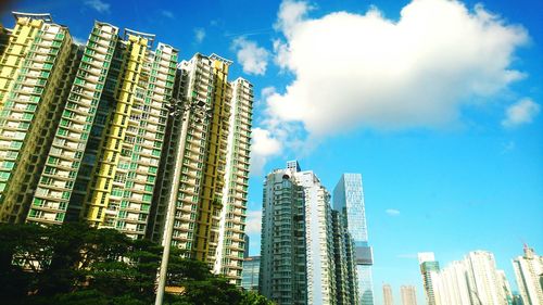 Low angle view of modern building against blue sky