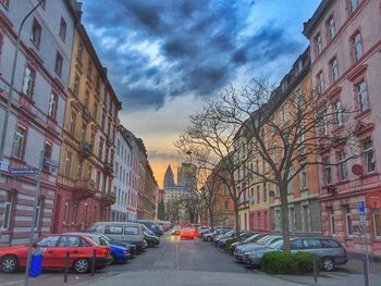 Buildings in city against cloudy sky