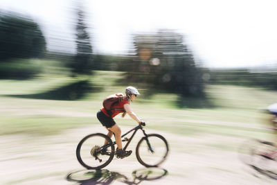 A young woman rides her mountain bike near mount hood, oregon.