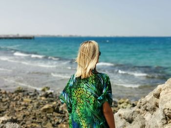 Rear view of woman looking at sea shore