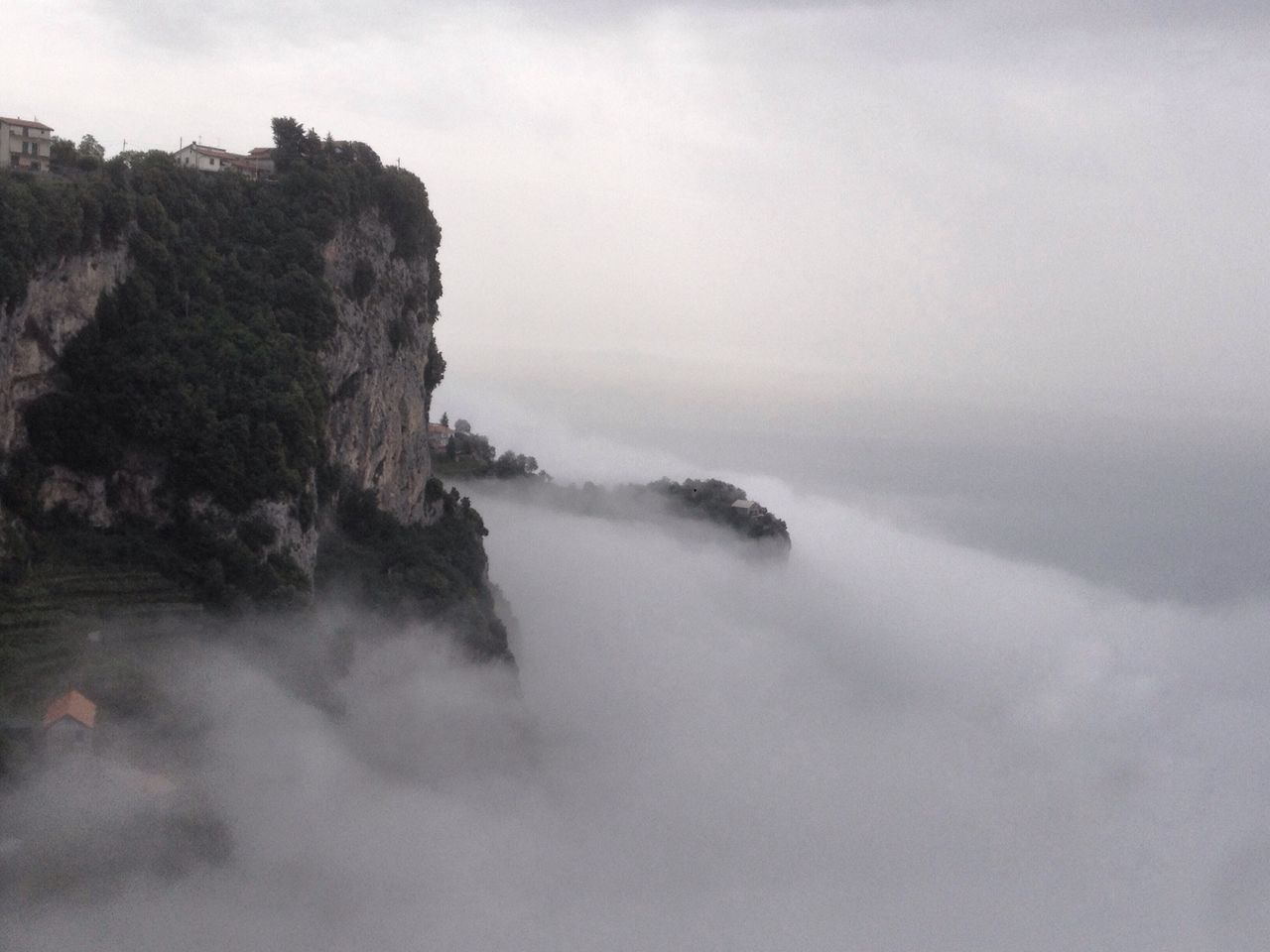 water, sky, tranquil scene, scenics, tranquility, beauty in nature, nature, rock - object, fog, cloud - sky, weather, sea, idyllic, non-urban scene, waterfront, outdoors, rock formation, mountain, day, river