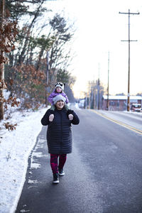 Little girl on mom's shoulders while out for a winter walk.