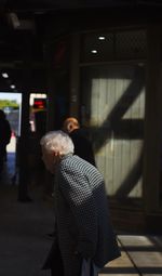 Rear view of people walking in corridor