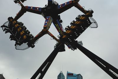 Low angle view of crane against sky