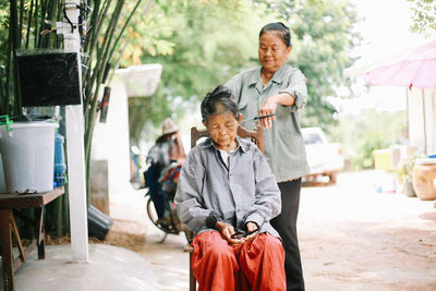 Portrait of smiling couple standing in city