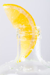 Close-up of drink in glass against white background