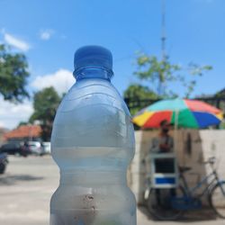 Close-up of water bottle against sky