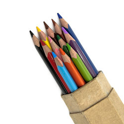 High angle view of colored pencils against white background