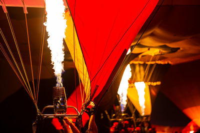 Illuminated lanterns hanging against sky at night