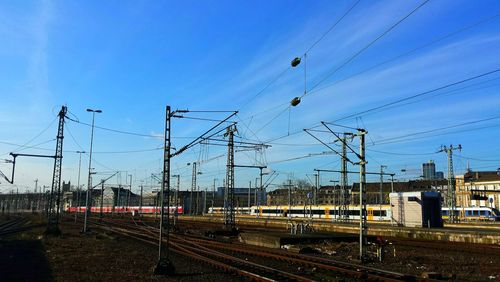 Trains and railroad tracks against blue sky