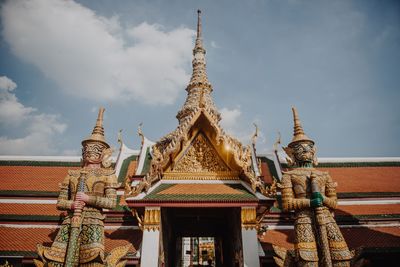 Low angle view of statue against temple building