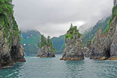 Panoramic shot of rocks in sea against sky