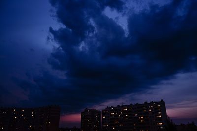 Storm clouds over city at night