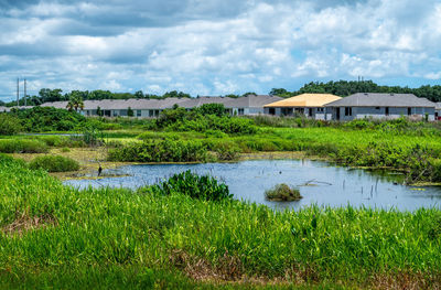 Scenic view of lake by building against sky