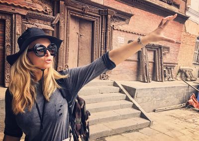 Woman gesturing while standing at bhaktapur