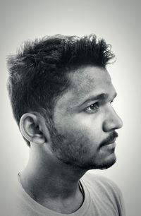 Close-up portrait of boy against white background