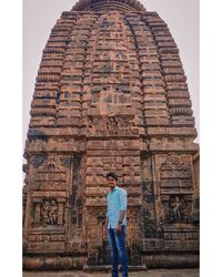 Rear view of man standing against temple