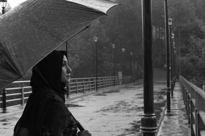 Side view of man with umbrella