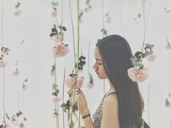 Woman standing amidst floral decoration