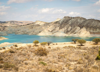 Scenic view of lake and mountains against sky