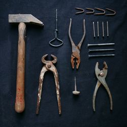 Close-up of hanging work tools in workshop