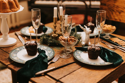 Tablescapes and christmas and new year time. decorated festive kitchen cozy table with glasses