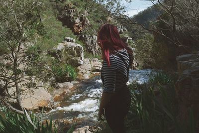 Young woman standing at forest