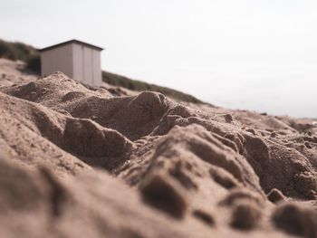 Surface level of sand on beach against clear sky