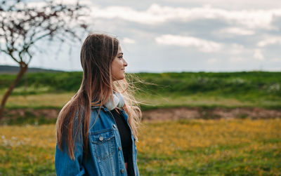 Young woman standing on field