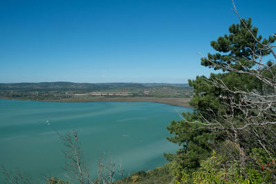 Scenic view of sea against clear blue sky