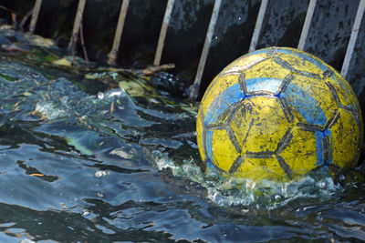 Close-up of soccer ball floating in lake