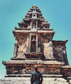 Rear view of man outside temple building