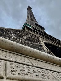 Low angle view of tower against cloudy sky