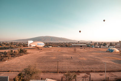 View of hot air balloon flying over land