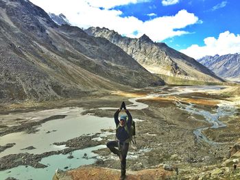 Hiker standing in tree pose by pin parvati pass