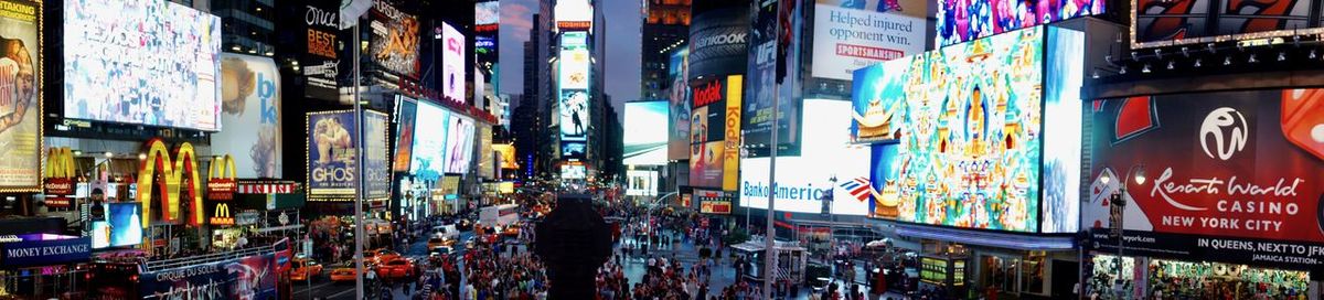 Panoramic view of city street at night