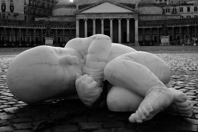 Close-up of statue against building in city