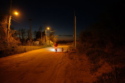 People walking on road at night