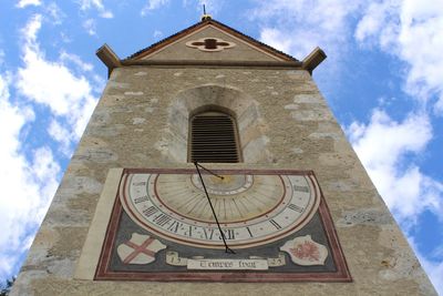 Low angle view of clock tower against sky